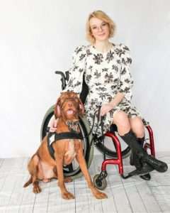 Woman with periodic paralysis and her service dog